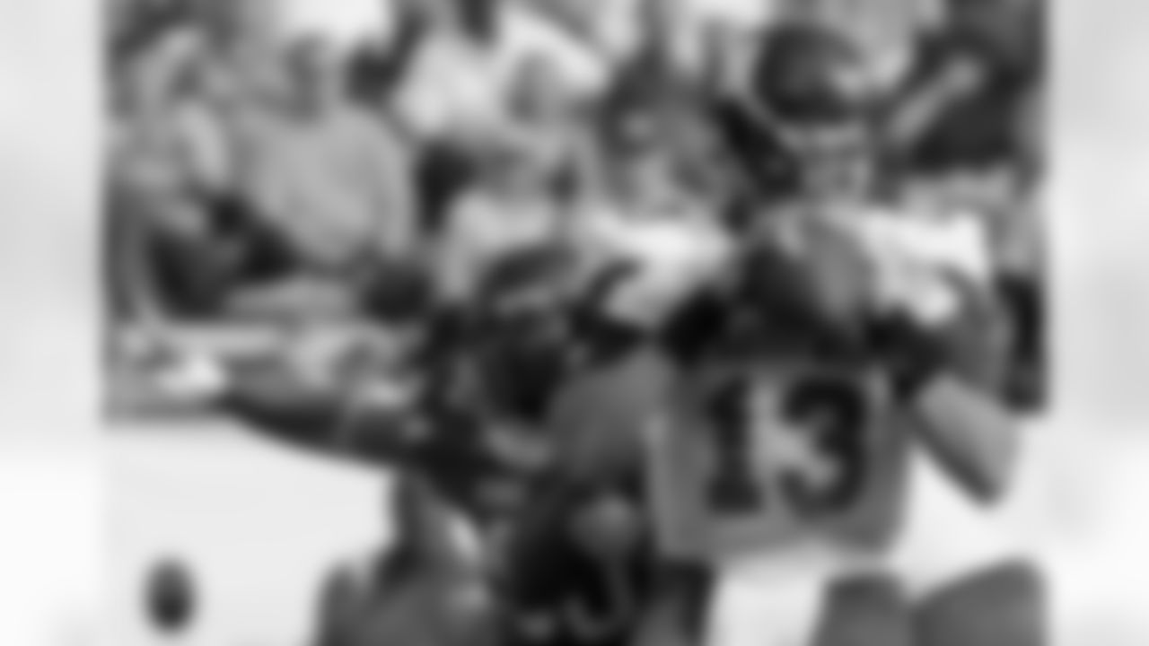 East quarterback Mike Kafka, right, of Northwestern, looks for an open receiver as West defensive lineman James Ruffin, of Northern Iowa, applies the pressure during the first half of the East West Shrine football game in Orlando, Fla., Saturday, Jan. 23, 2010. The East won 13-10. (AP Photo/Phelan M. Ebenhack)