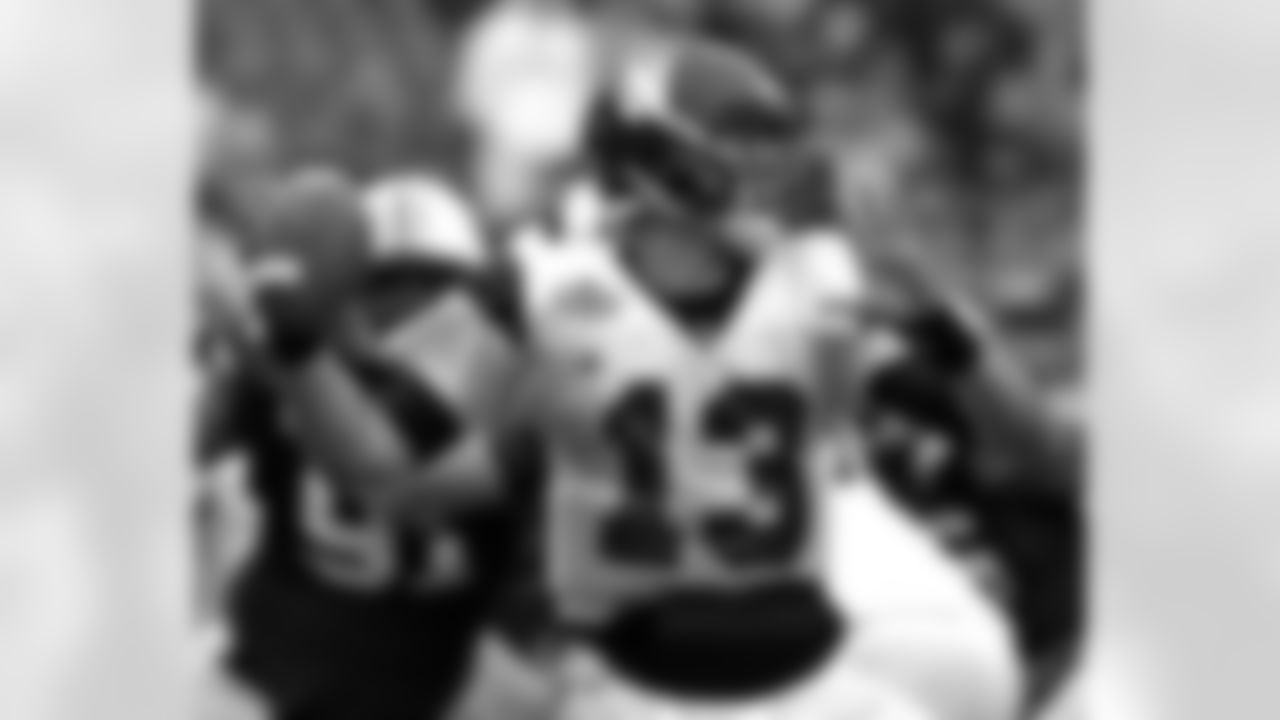 Northwestern quarterback Mike Kafka (13) fires a pass as Auburn defensive tackle Jake Ricks (91) rushes in during the second half of the Outback Bowl NCAA college football game Friday, Jan. 1, 2010, in Tampa, Fla.  Kafka threw for a career-best 532 yards and four touchdowns, but Auburn won 38-35 in overtime. (AP Photo/Chris O'Meara)