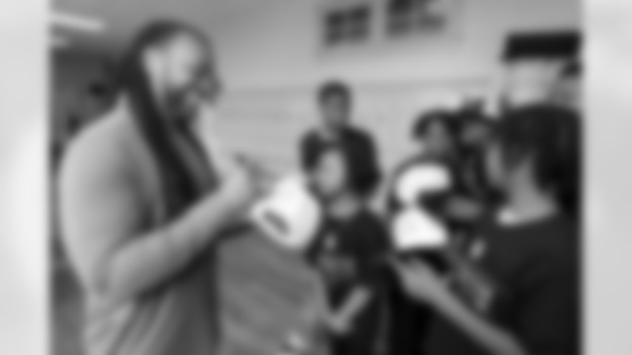 Usama Young, former safety for the New Orleans Saints, signs hats for students during the Character Playbook Speaker Series on Wednesday, Feb. 5, 2025 at Bricolage Academy in New Orleans. Funded by the NFL Foundation, Character Playbook is a digital education resource that supports positive character development, mental wellness and healthy relationships in middle and high school students. The Healthy Relationships program is available nationally to middle school students at no cost to K-12 schools, having reached more than 3 million students nationwide. (Doug Benc/AP Content Services for the NFL)