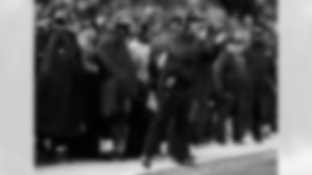Baltimore Ravens head coach John Harbaugh, front, claps as he looks on from the sideline in the first half of an NFL football game against the New York Giants in Baltimore, Sunday, Dec. 23, 2012. (AP Photo/Nick Wass)