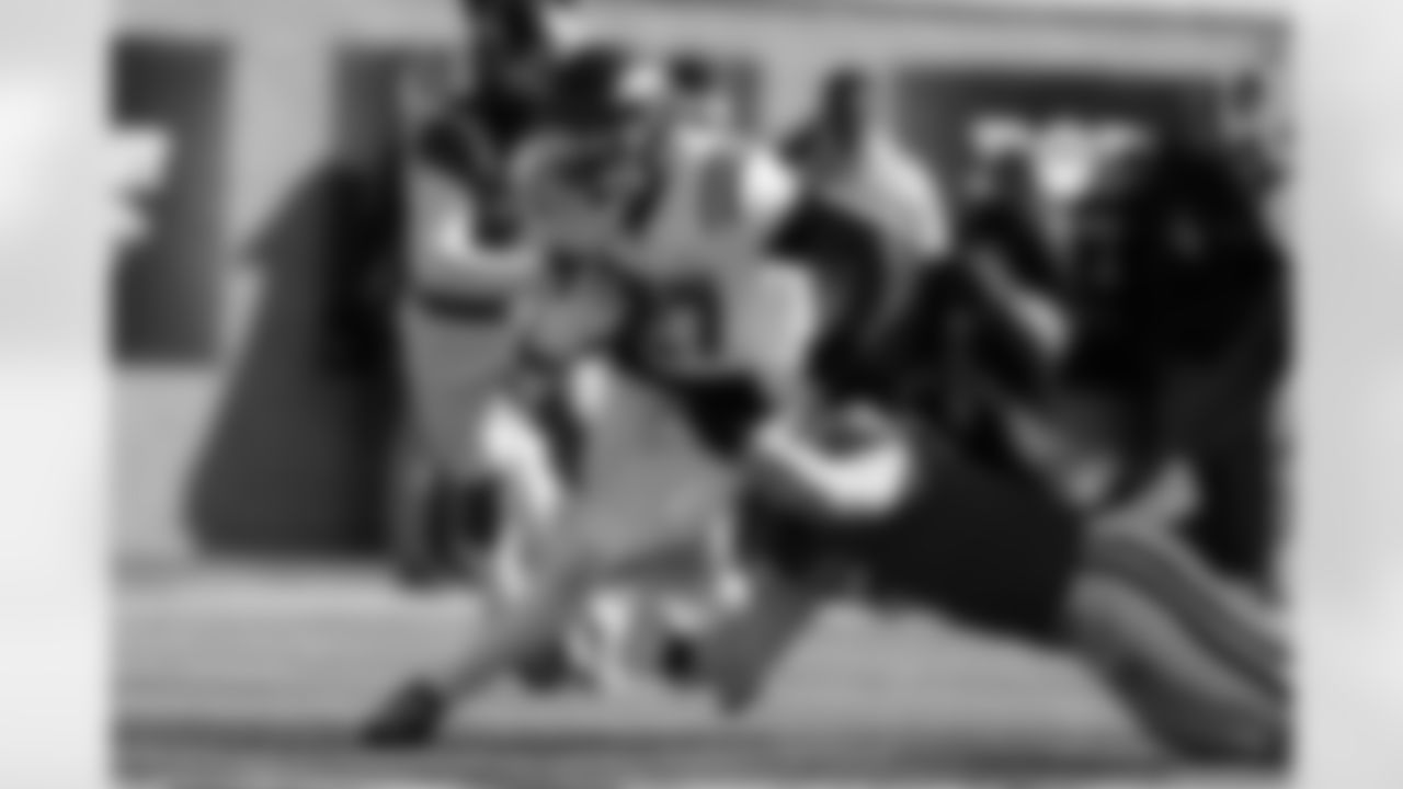 American Team running back Mike Washington Jr. (27), of Arkansas, carries the ball during the first half of the Senior Bowl NCAA college football game Saturday, Jan. 31, 2026, in Mobile, Ala. (AP Photo/Butch Dill)