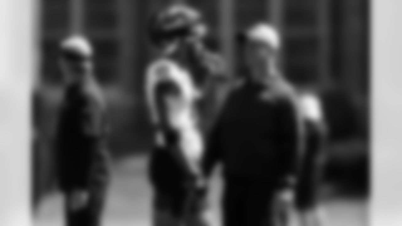 Baltimore Ravens rookie wide receiver Rashod Bateman talks with head coach John Harbaugh, right, during NFL football rookie minicamp Saturday, May 15, 2021 in Owings Mills, Md. (AP Photo/Gail Burton)