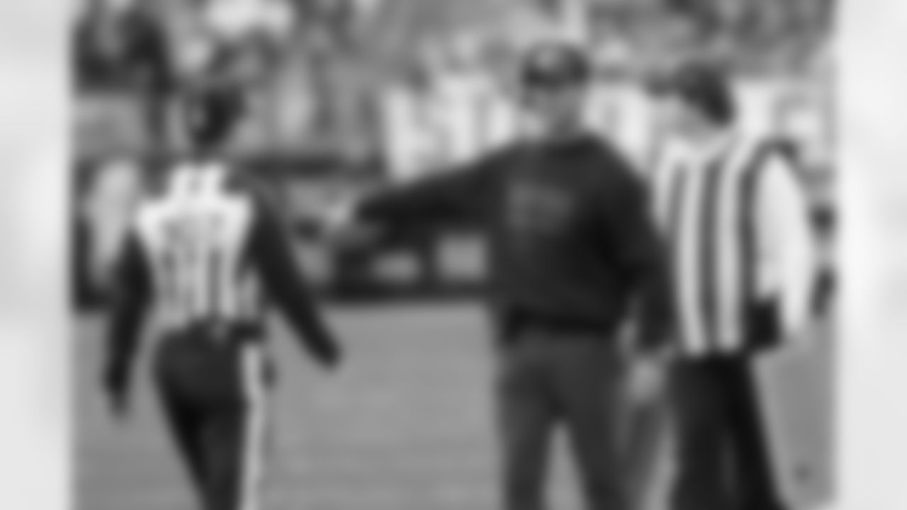 Baltimore Ravens head coach John Harbaugh, center, talks to side judge Dave Hawkshaw (107) during the second half of an NFL football game against the Pittsburgh Steelers, Sunday, Nov. 17, 2024, in Pittsburgh. (AP Photo/Matt Freed)