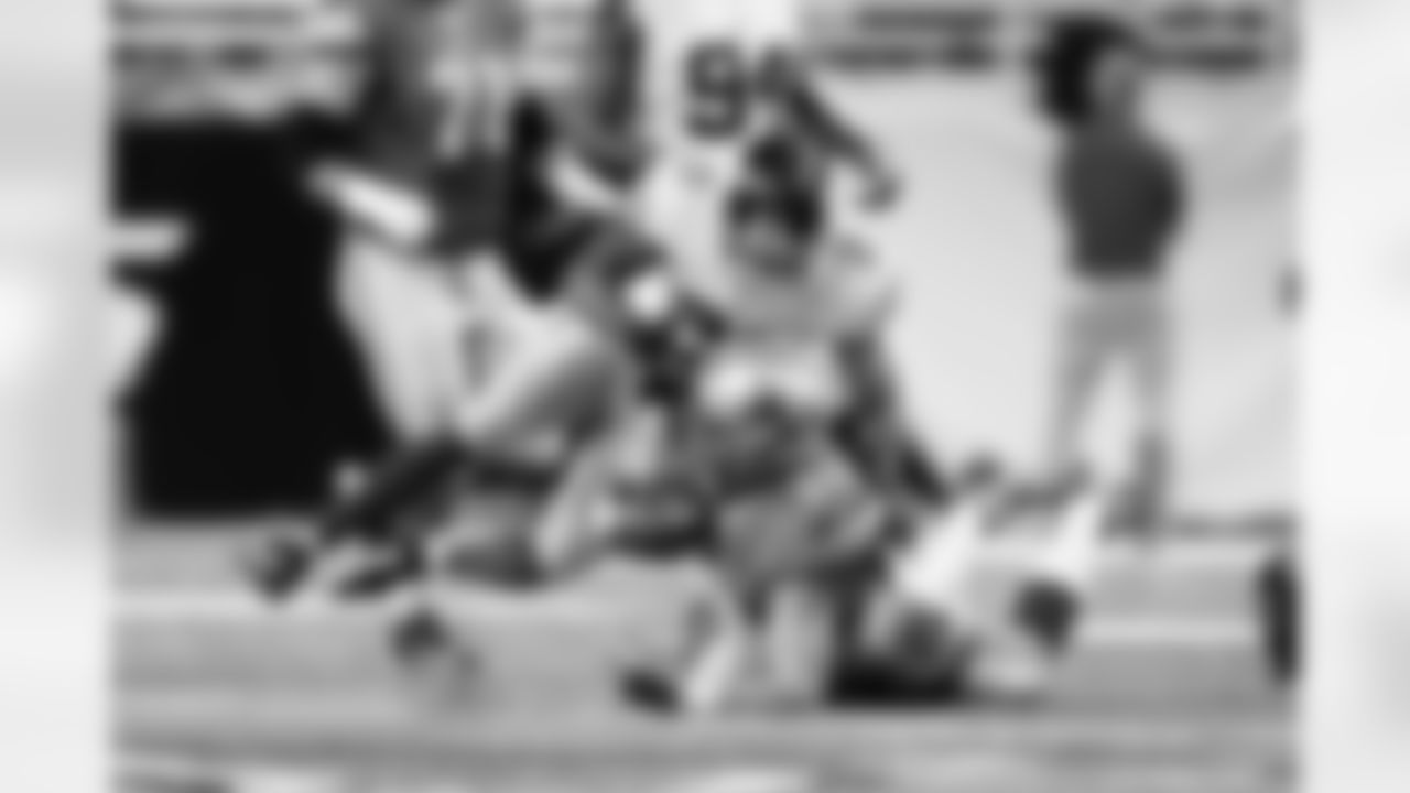 Detroit Lions tight end Joseph Fauria (80) is tackled by New York Giants free safety Ryan Mundy, left, and free safety Will Hill, right, during an NFL football game at Ford Field in Detroit, Sunday, Dec. 22, 2013. (AP Photo/Rick Osentoski)