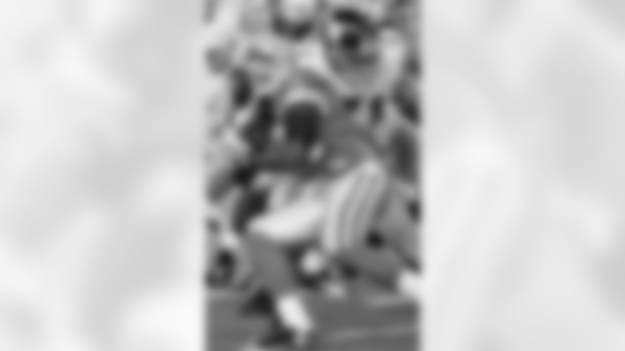 Detroit Lions running back Kevin Smith, foreground, is wrapped up by New York Giants defensive end Dave Tollefson, right, in the first half of an NFL preseason football game Thursday, Aug. 7, 2008, in Detroit. (AP Photo/Duane Burleson)