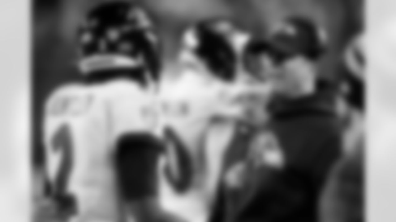 Baltimore Ravens head coach John Harbaugh, right, talks with quarterback Tyler Huntley (2) in the first half of an NFL wild-card playoff football game against the Cincinnati Bengals in Cincinnati, Sunday, Jan. 15, 2023. (AP Photo/Darron Cummings)