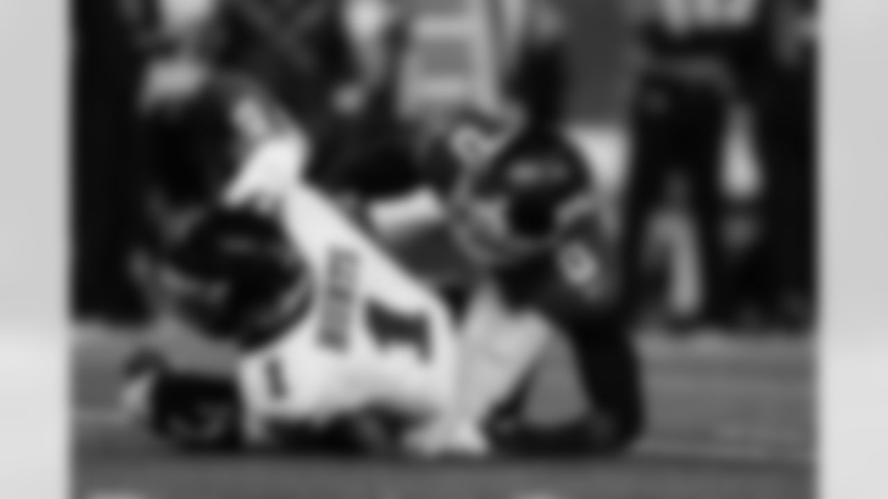 New York Giants outside linebacker Brian Burns (0) sacks Philadelphia Eagles quarterback Jalen Hurts (1) during an NFL football game, Thursday, Oct. 9, 2025 in East Rutherford, N.J. (Kathryn Riley via AP)