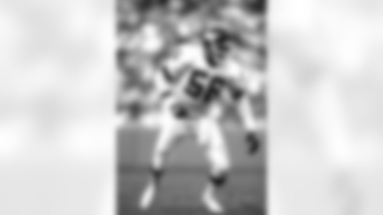 New York Giants defensive end Lawrence Taylor (56) rushes the passer in 1990. (AP Photo / Al Messerschmidt)