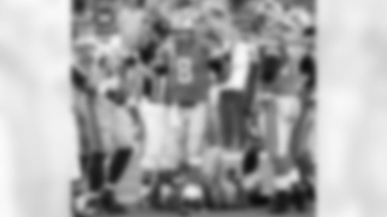 Detroit Lions quarterback Jon Kitna (8) looks for a play from the bench as teammate Jeff Backus (76) and New York Giants' Michael Strahan look on in the first half of the Lions 16-10 loss in a football game Sunday, Nov. 18, 2007 in Detroit. (AP Photo/Duane Burleson)