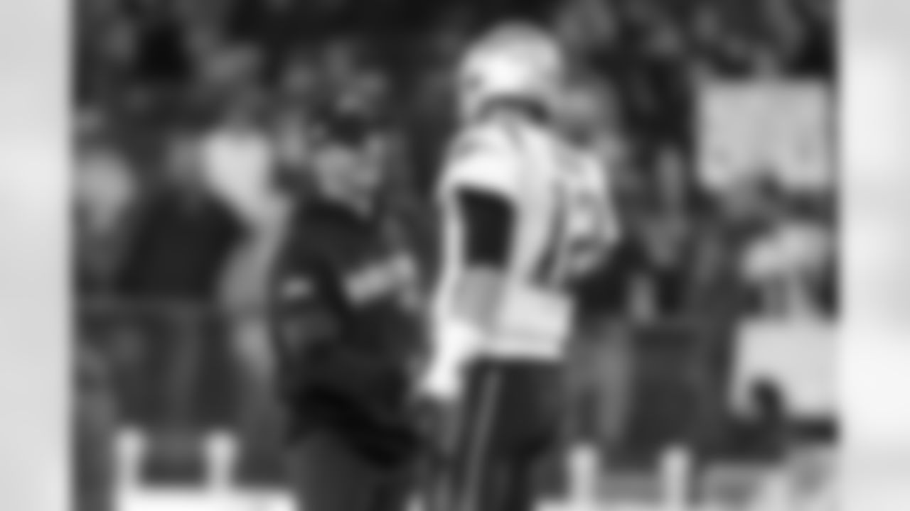 Baltimore Ravens head coach John Harbaugh, left, talks with New England Patriots quarterback Tom Brady prior to an NFL football game, Sunday, Nov. 3, 2019, in Baltimore. (AP Photo/Julio Cortez)