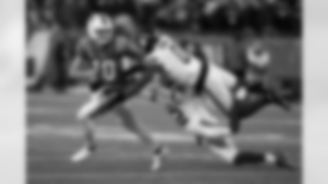 New England Patriots quarterback Drake Maye, left, scrambles away from New York Giants cornerback Dru Phillips, bottom left, and linebacker Brian Burns (0) during the first half of an NFL football game Monday, Dec. 1, 2025, in Foxborough, Mass. (AP Photo/Charles Krupa)