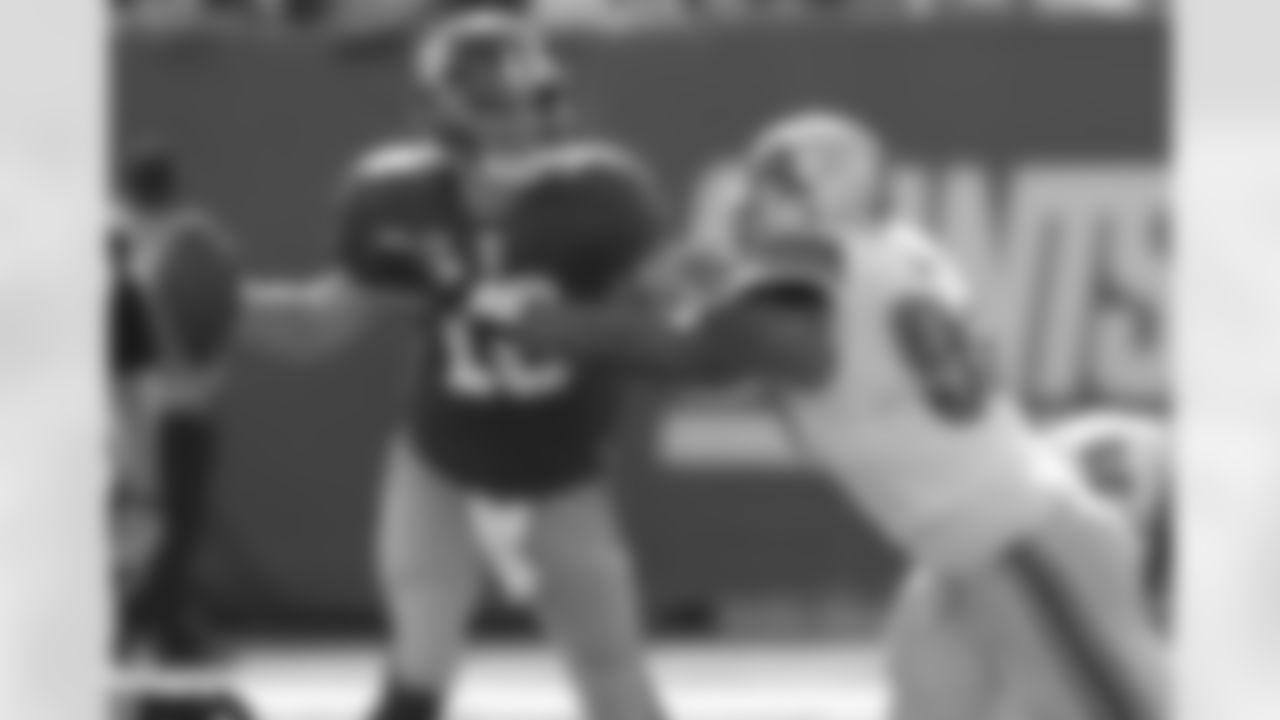 New York Giants quarterback Eli Manning (10) is sacked by Detroit Lions defensive tackle Ndamukong Suh (90) during the second quarter of an NFL football game between the Detroit Lions and the New York Giants at New Meadowlands Stadium Sunday, Oct. 17, 2010, in East Rutherford, N.J. (AP Photo/Seth Wenig)