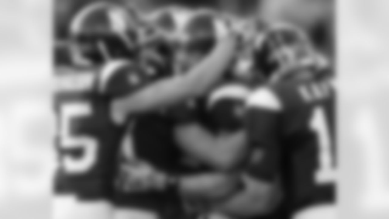 Northwestern's Andrew Brewer, center, celebrates his touchdown with teammates, including Zeke Markshausen, left, and Mike Kafka, right, during the second quarter of an NCAA college football game against Wisconsin in Evanston, Ill., Saturday, Nov. 21, 2009. (AP Photo/Nam Y. Huh)