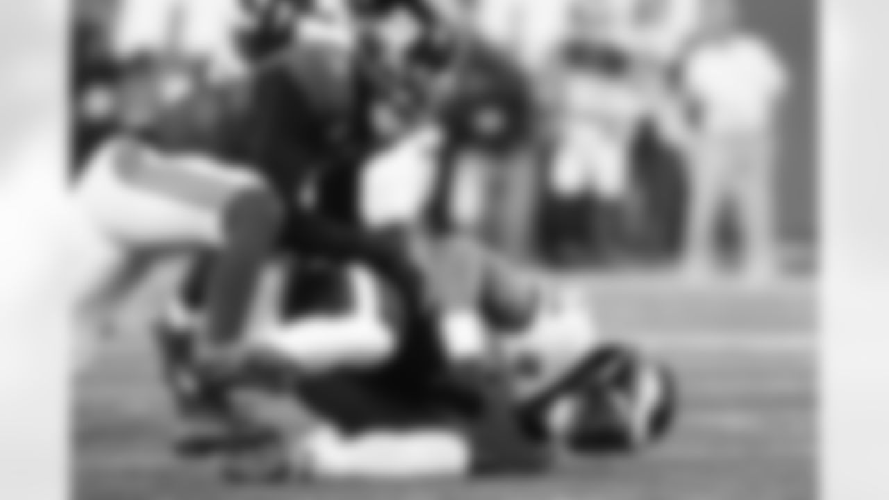 New York Giants linebacker Brian Burns (0) sacks Philadelphia Eagles quarterback Jalen Hurts (1) during an NFL football game, Thursday, Oct. 9, 2025, in East Rutherford, N.J. (Margaret Bowles via AP)