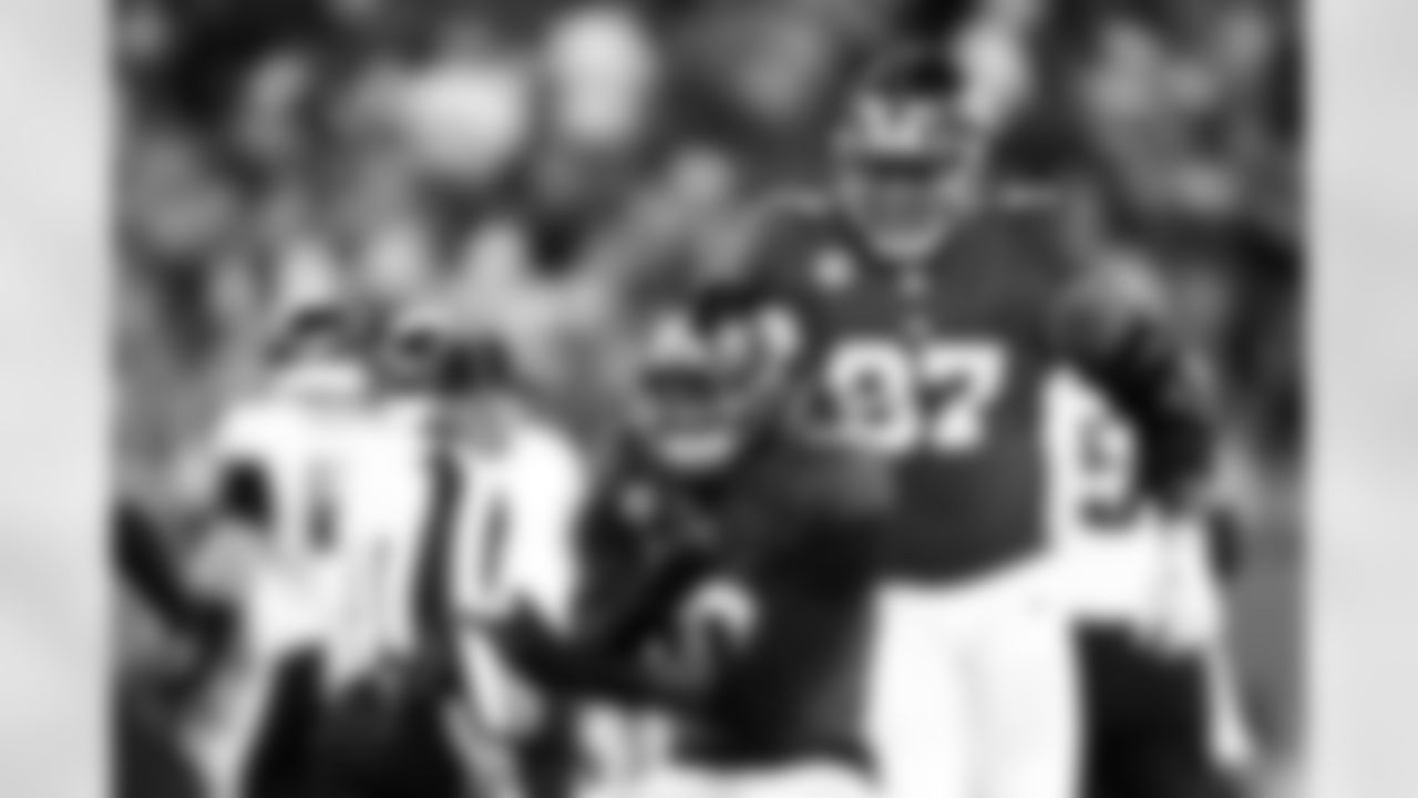 New York Giants outside linebacker Brian Burns (0) celebrates after a sack during an NFL football game against the Philadelphia Eagles, Thursday, Oct. 9, 2025 in East Rutherford, N.J. (Kevin Sabitus via AP)