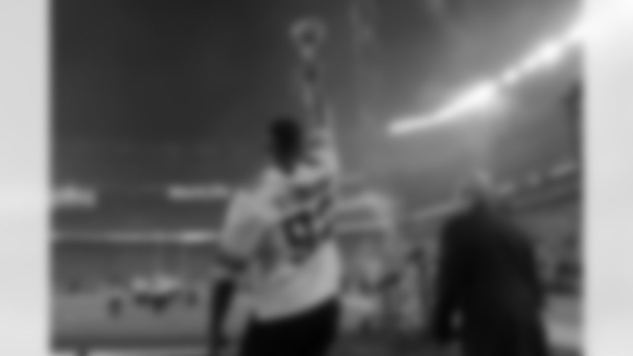 New York Giants former coach Tom Coughlin (right) and former defensive end Michael Strahan (92) carry the Lombardi Trophy onto the field during halftime ceremony to recognize the 10th anniversary of the Giants' victory in Super Bowl XLII at a NFL football game in East Rutherford, N.J. on Monday, September 18, 2017. (Kirby Lee via AP)