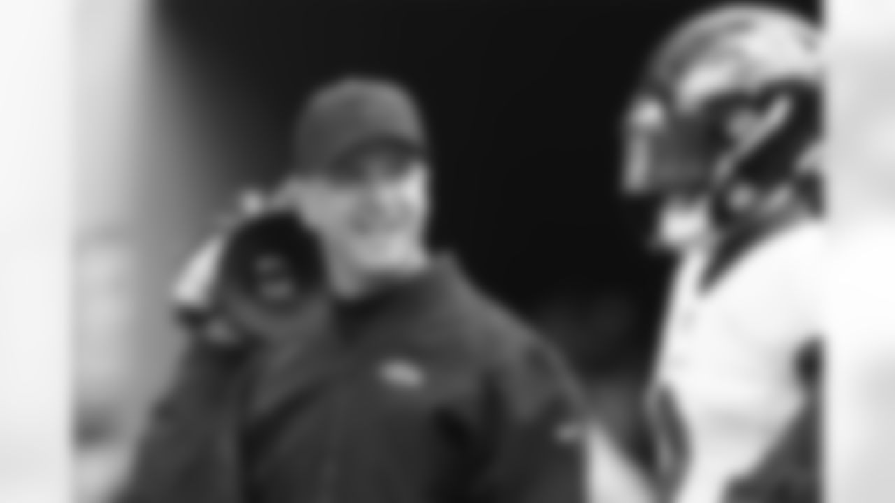 Baltimore Ravens Head coach John Harbaugh speaks with Baltimore Ravens quarterback Tyler Huntley (2) before an NFL football game against the Chicago Bears Sunday, Nov 21. 2021, in Chicago. (AP Photo/Jeffrey Phelps)