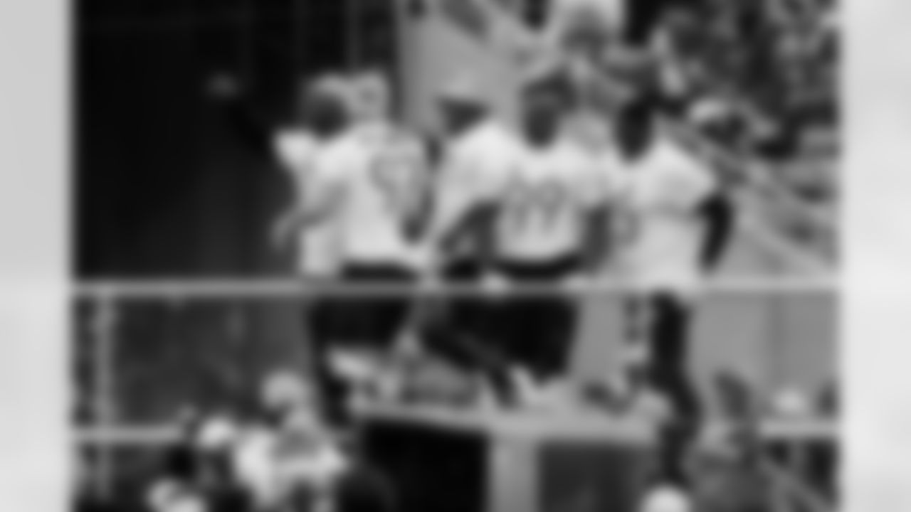 NFL players Detroit Lions defensive end Aidan Hutchinson (97), Minnesota Vikings linebacker Danielle Hunter (99), Dallas Cowboys offensive tackle Tyler Smith (73), Carolina Panthers defensive tackle Derrick Brown (95) and New York Giants defensive tackle Dexter Lawrence II (97) celebrate after the tug of war skills challenge event at the NFL Pro Bowl football game, Sunday, Feb. 4, 2024, in Orlando, Fla. (Aaron M. Sprecher via AP)