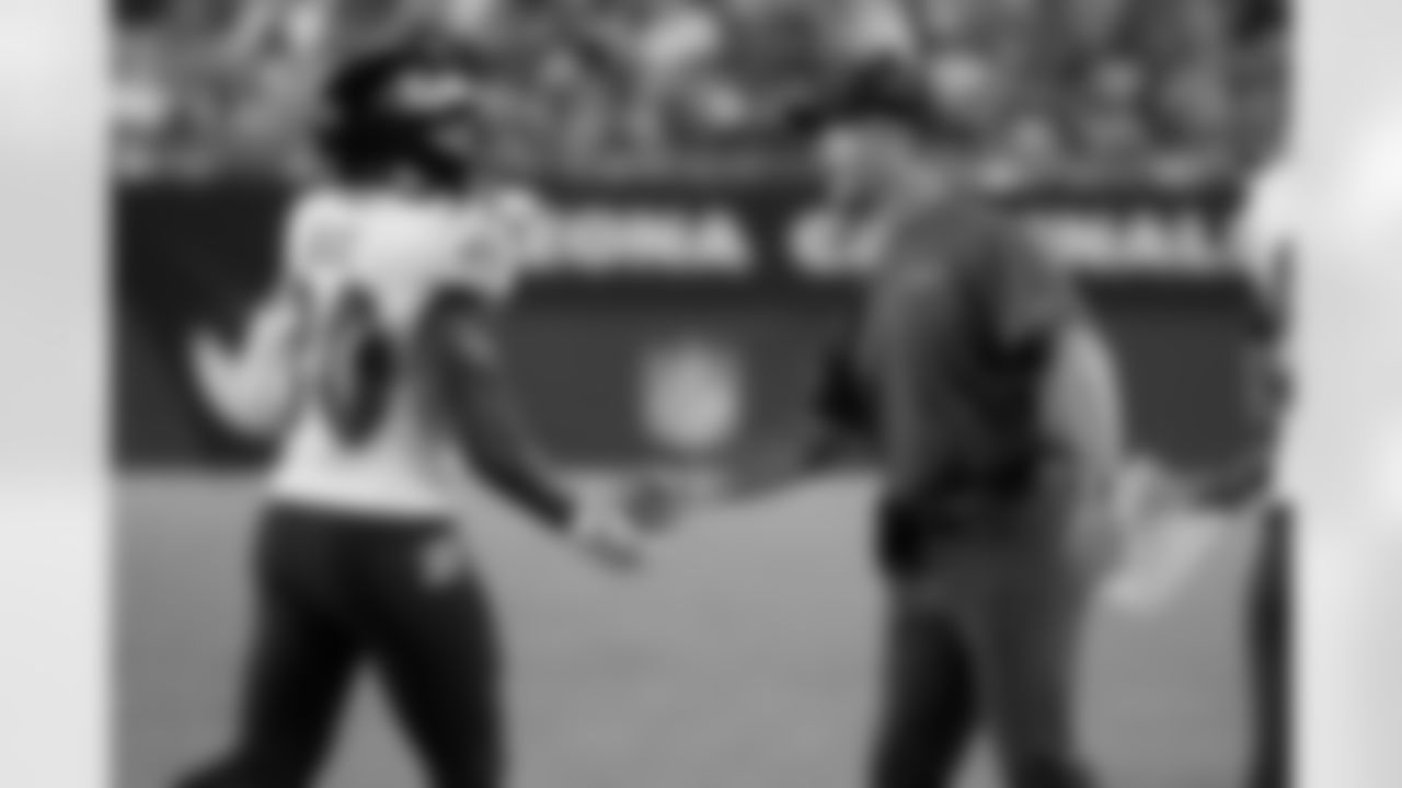 Baltimore Ravens head coach John Harbaugh greets running back Tyler Badie (30) after his touchdown against the Arizona Cardinals during the second half of an NFL preseason football game, Sunday, Aug. 21, 2022, in Glendale, Ariz. (AP Photo/Rick Scuteri)