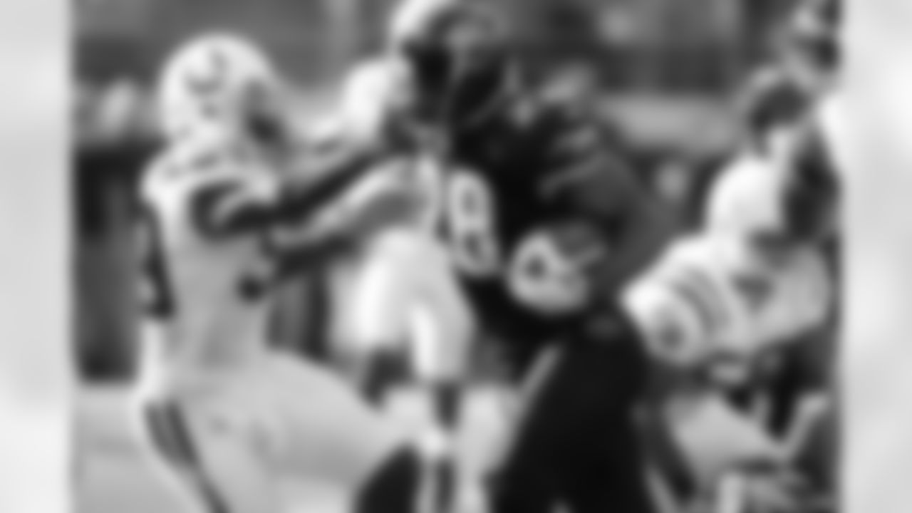 Fred Taylor #28 of the Jacksonville Jaguars pushes away Cato June #59 of the Indianapolis Colts on a rushing play during an NFL football game on Dec. 10, 2006 in Jacksonville, Fla. The Jaguars defeated the Colts 44-17. (Joe Robbins via AP)