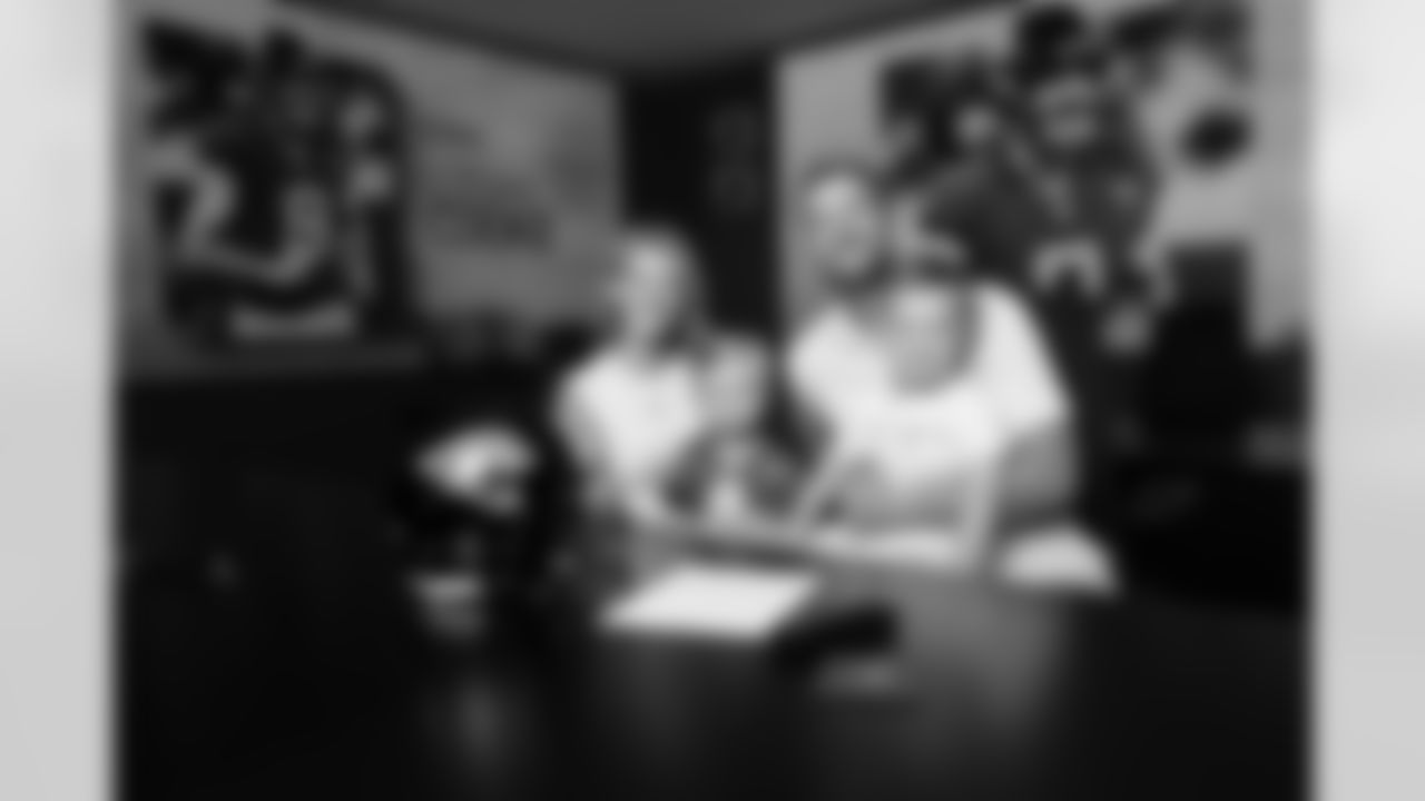 Jacksonville, Fla. — Jaguars punter Logan Cooke poses with his family after signing a contract extension at the Miller Electric Center on June 10, 2025.