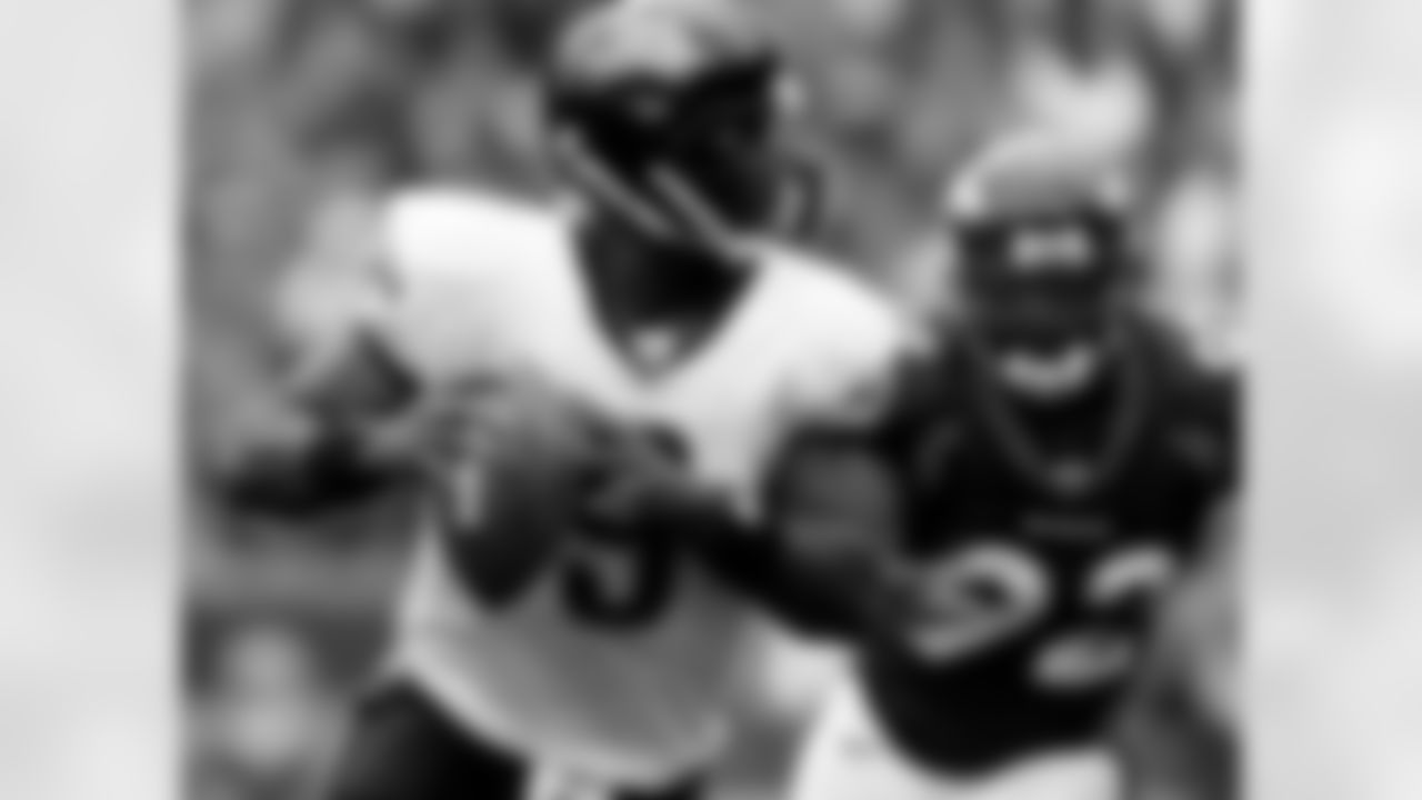 Jacksonville Jaguars quarterback David Garrard (9) is pursued by Denver Broncos defensive end Elvis Dumervil in the first quarter of the Jaguars' 24-13 victory in a football game in Denver on Sunday, Sept. 23, 2007. (AP Photo/David Zalubowski)