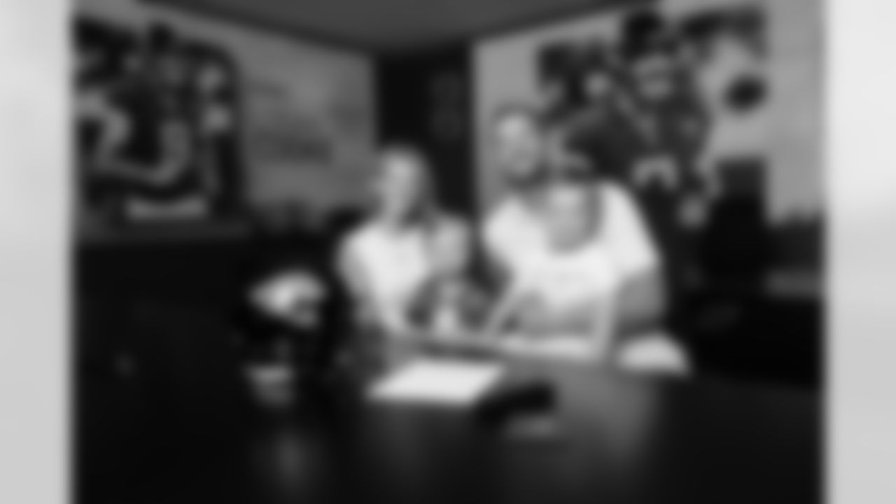 Jacksonville, Fla. — Jaguars punter Logan Cooke poses with his family after signing a contract extension at the Miller Electric Center on June 10, 2025.