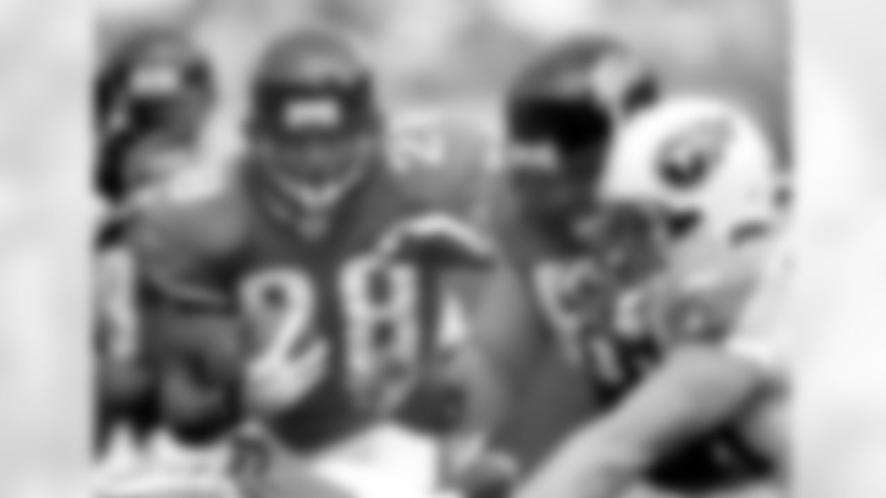 Jacksonville Jaguars running back Fred Taylor, left, runs behind the block of teammate Chad Naeole, center, as Tennessee Titans defender Kyle Vander Bosch, right, works during an NFL football game, Sunday, Nov. 5, 2006, in Jacksonville, Fla. (AP Photo/Phil Coale)