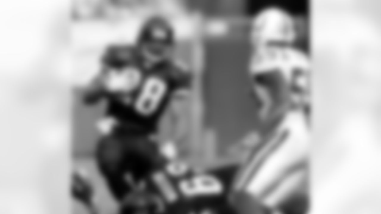 Jacksonville Jaguars running back Fred Taylor, left, runs around the block of teammate Brad Meester, bottom, as Indianapolis Colts defender Cato June, right, moves in on the play during the first quarter of a National Football League game, Sunday, Dec. 10, 2006, in Jacksonville, Fla. (AP Photo/Phil Coale)