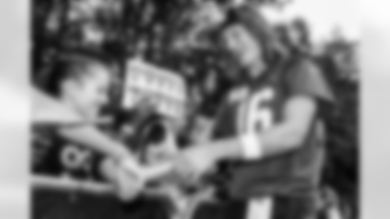 Watford, U.K. — Jaguars quarterback Trevor Lawrence (16) greets JagTag athletes after practice at The Grove on October 17, 2025.