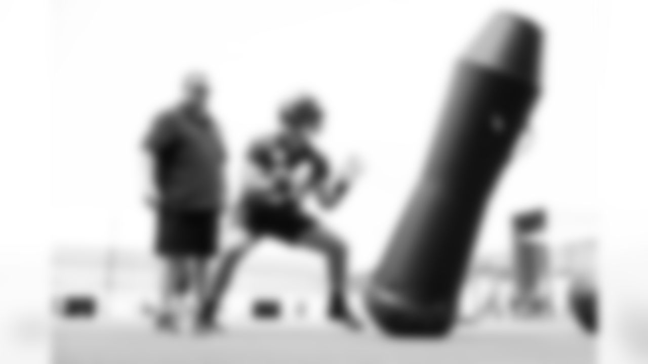 Jacksonville, Fla. — Jaguars offensive line coach Shaun Sarrett and offensive lineman Wyatt Milum (64) during rookie minicamp at the Miller Electric Center on May 10, 2025.
