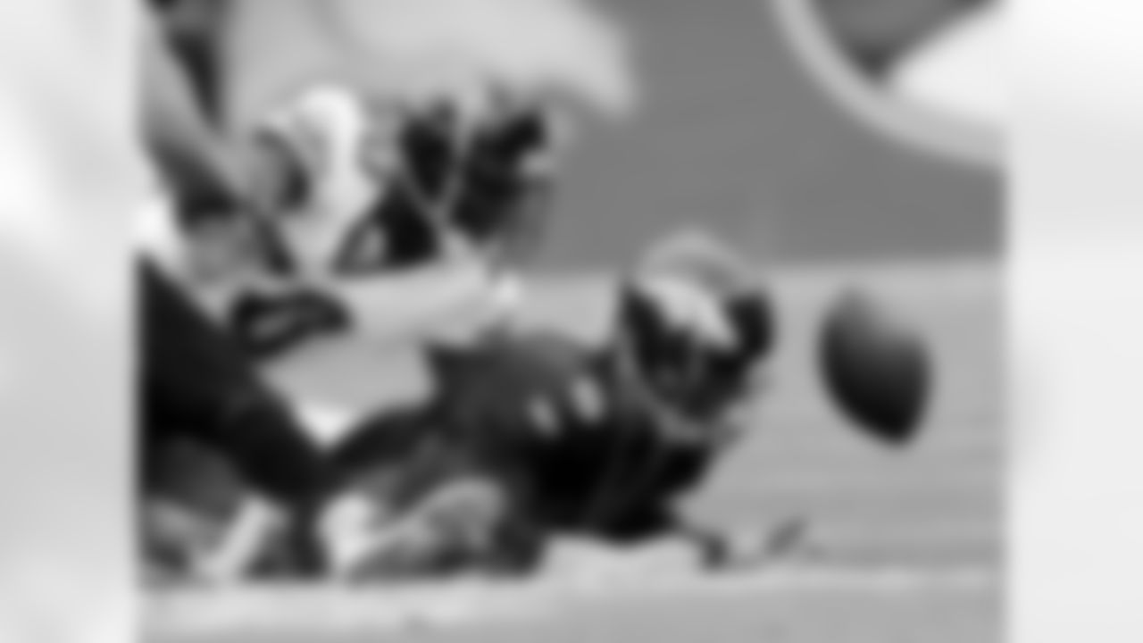 Denver Broncos quarterback Jay Cutler, right, tries to recover his own fumble after getting hit by Jacksonville Jaguars' Reggie Hayward (not shown) in the first quarter of an NFL football game in Denver on Sunday, Oct. 12, 2008. Jacksonville Jaguars' Pierson Prioleau is in on the play at right. Jacksonville recovered the ball. (AP Photo/David Zalubowski)