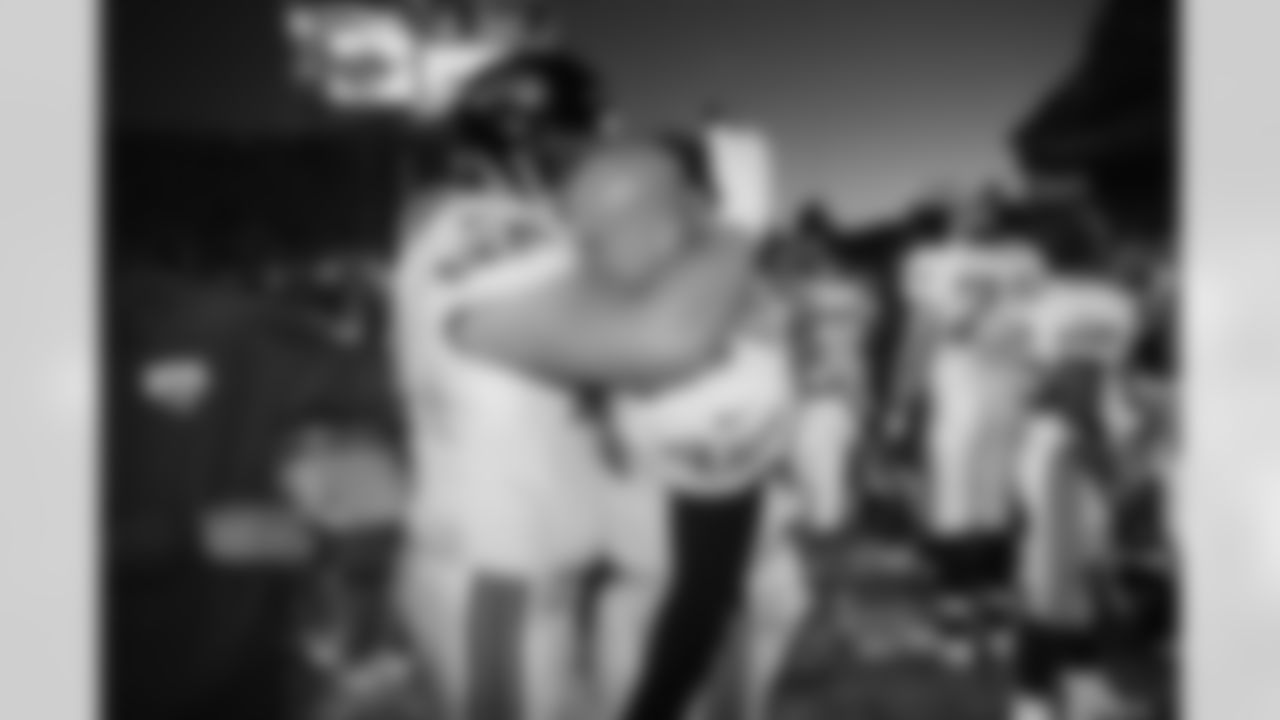 Jacksonville Jaguars' Brian DeMarco, left, and Michael Cheever hug after their 30-27 win over the Denver Broncos in their AFC playoff game in Denver on Saturday, Jan. 4, 1997. (AP Photo/David Zalubowski)