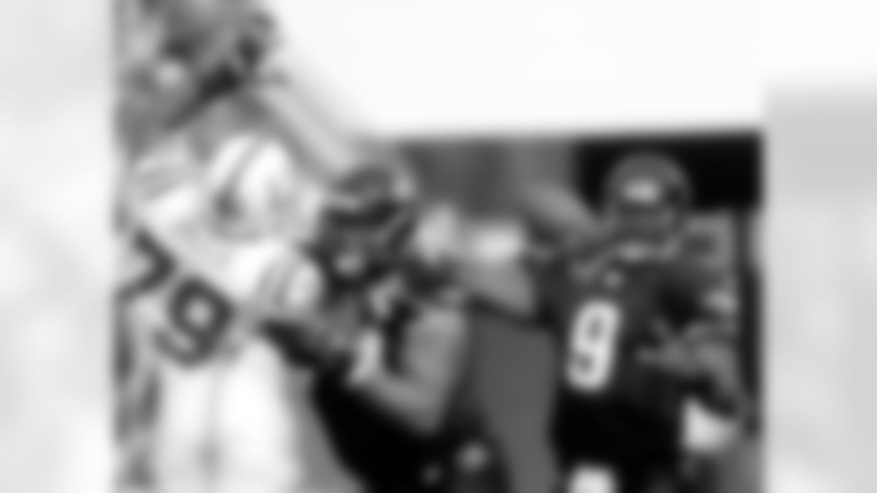 Jacksonville Jaguars quarterback David Garrard, right, sets to throw a second-quarter pass as teammate Maurice Williams, center, blocks Indianapolis Colts' Raheem Brock, left, during an NFL football game, Sunday, Dec. 10, 2006, in Jacksonville, Fla. The Jaguars won 44-17. (AP Photo/Phil Coale)