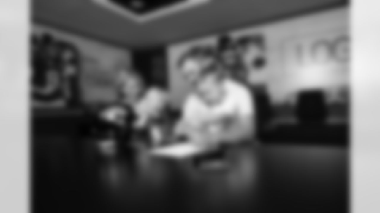 Jacksonville, Fla. — Jaguars punter Logan Cooke poses with his family after signing a contract extension at the Miller Electric Center on June 10, 2025.