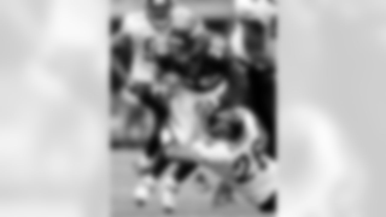 Denver Broncos running back Travis Henry (20) it tackled by Jacksonville Jaguars safety Sammy Knight (26) during the fourth quarter of a football game in Denver, Sunday, Sept. 23, 2007. The Jaguars beat the Broncos 23-14. (AP Photo/Jack Dempsey)