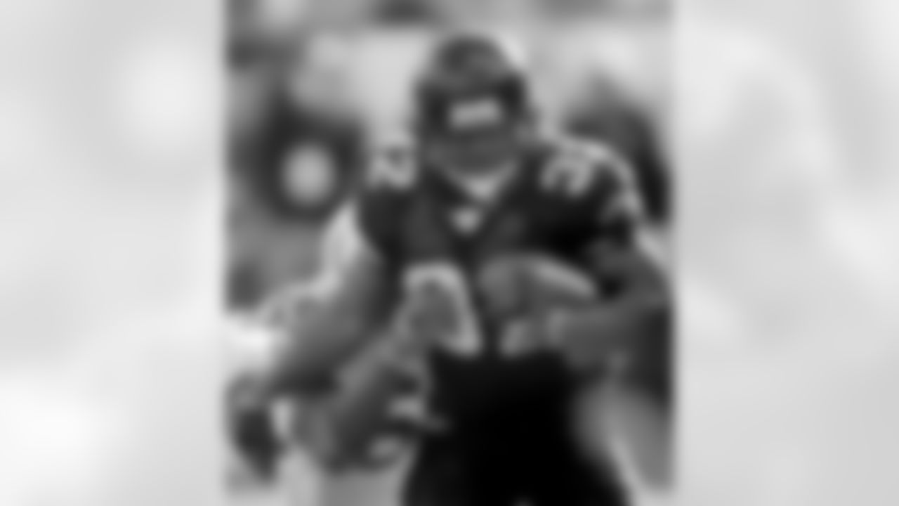 Jacksonville Jaguars running back Maurice Jones-Drew, front, runs for third-quarter yardage as Indianapolis Colts defender Cato June attempts to make the tackle during an NFL football game Sunday, Dec. 10, 2006, in Jacksonville, Fla. The Jaguars won 44-17. (AP Photo/Phil Coale)