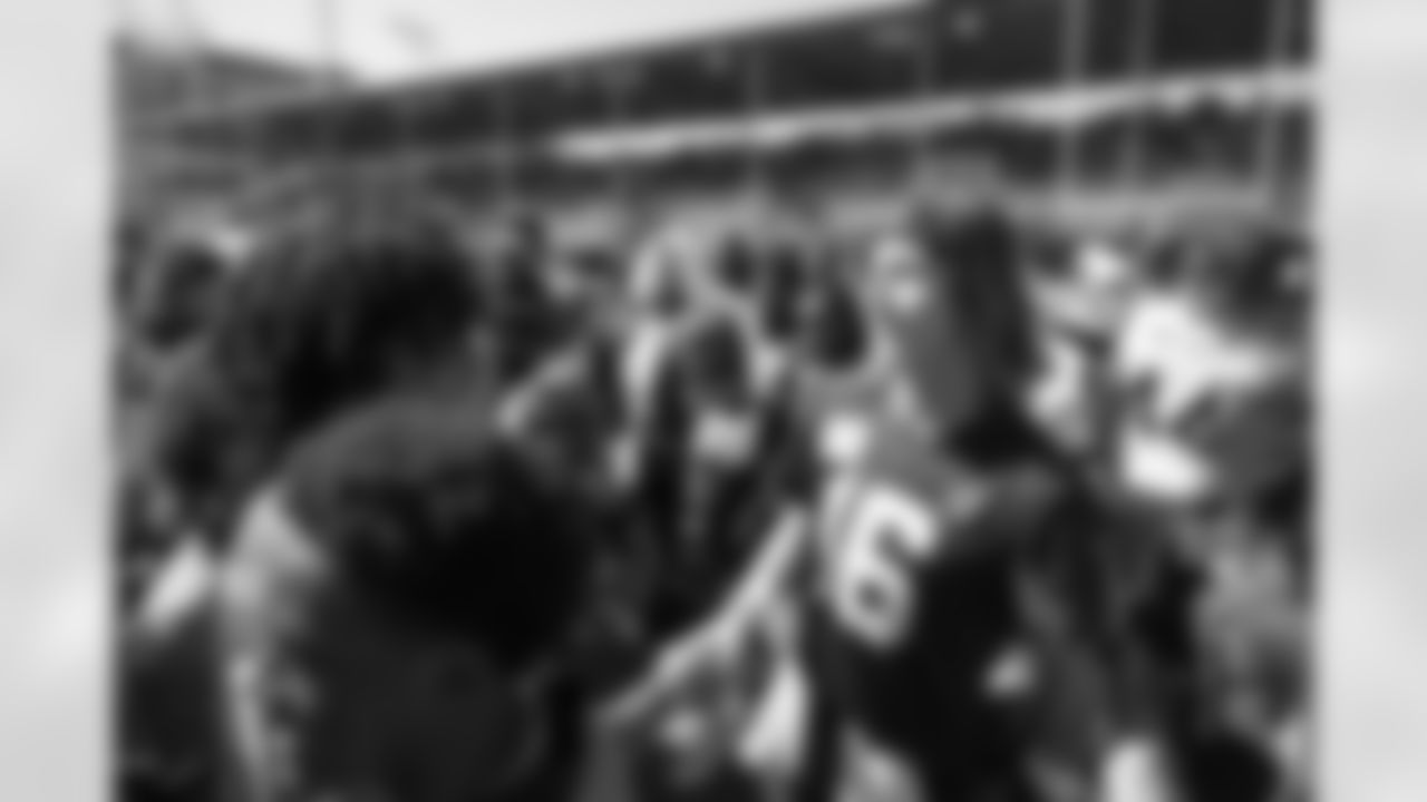 Jacksonville, Fla. — Jaguars quarterback Trevor Lawrence (16) greets the 14U Jaguars Elite Boys NFL Flag champions during training camp at the Miller Electric Center on July 27, 2025.