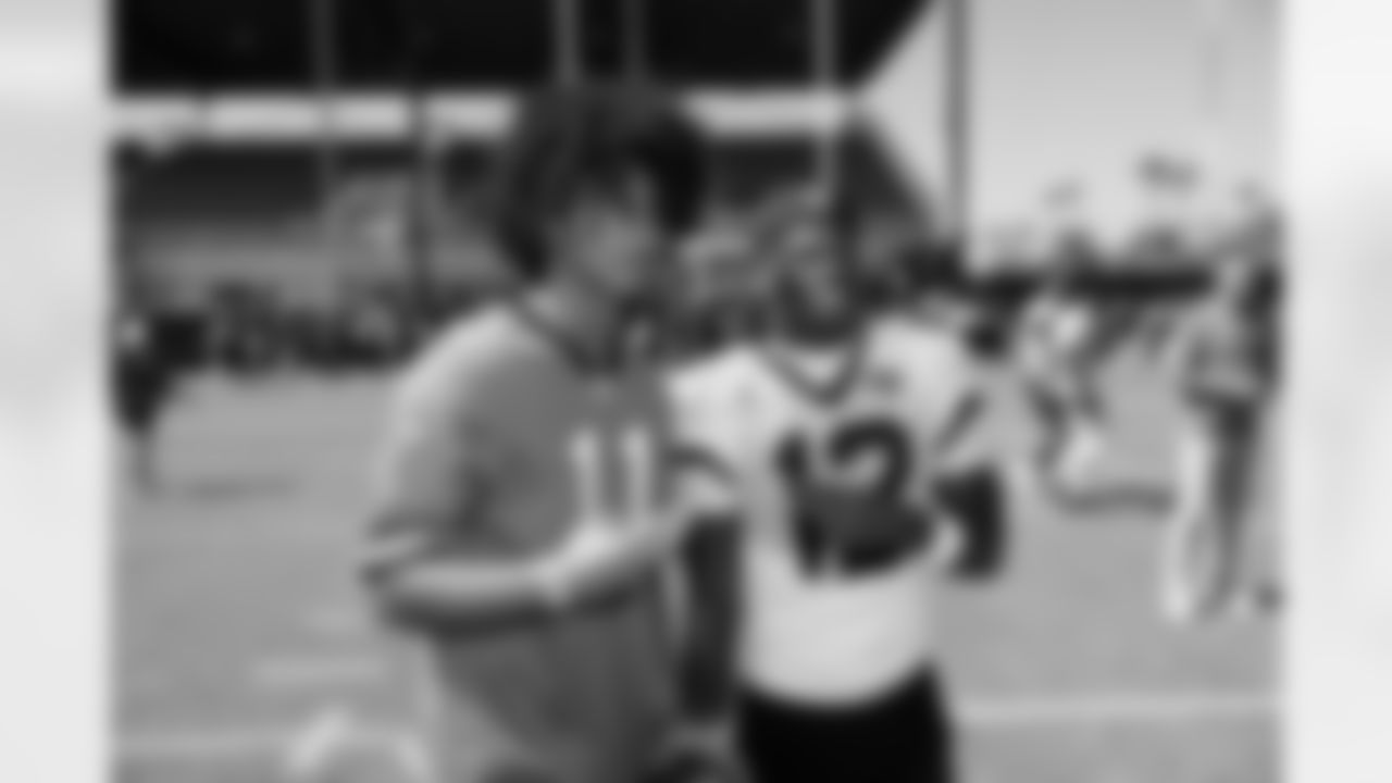 Jacksonville, Fla. — Jaguars wide receiver/defensive back Travis Hunter (12) greets the 14U Jaguars Elite Boys NFL Flag champions during training camp at the Miller Electric Center on July 27, 2025.