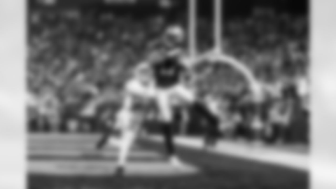 Las Vegas Raiders wide receiver Davante Adams (17) completes a pass against Los Angeles Chargers safety Alohi Gilman (32) for a touchdown during an NFL football game between the Las Vegas Raiders and the Los Angeles Chargers, Thursday, Dec. 14, 2023 in Las Vegas. (Michael Owens via AP)