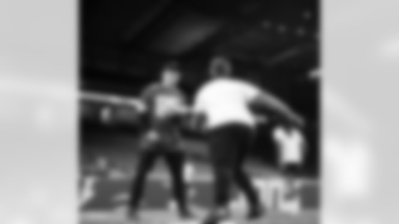 Detroit Lions wide receiver Tom Kennedy (85) and a participant doing a drill at the running back station during the Inspire Change Football Clinic at Ford Field on Dec. 9, 2025 in Detroit. (Izzy Rincon/Detroit Lions)