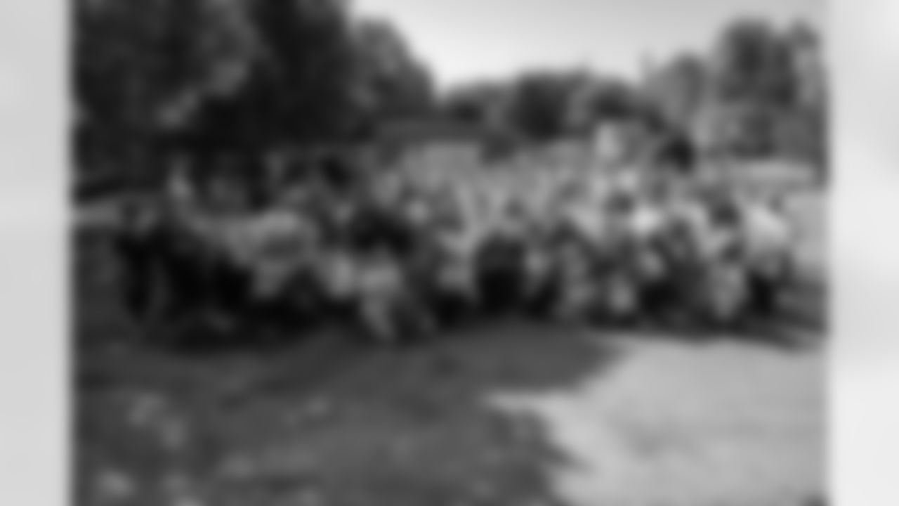 Volunteers take a group photo during a spring cleanup event at the Delray Community Center on June 10, 2025 in Detroit. (Mike Ferdinande/Detroit Lions)
