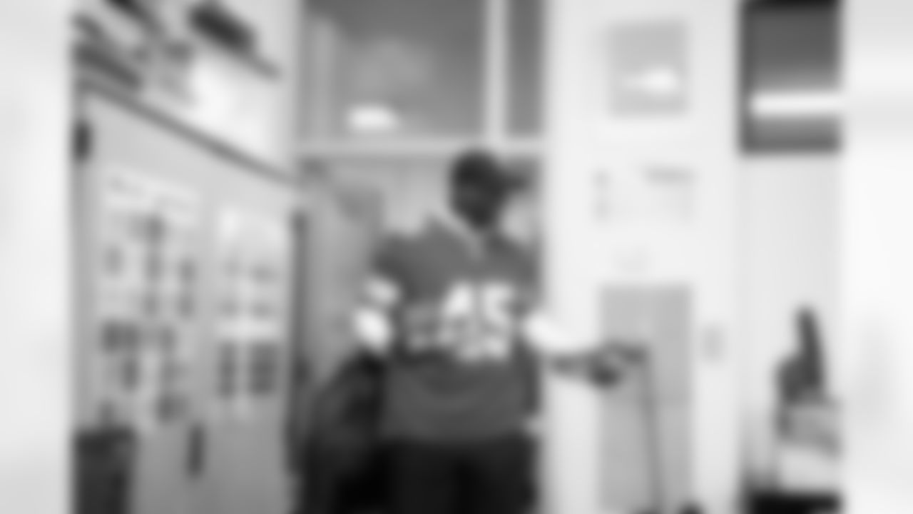 Lions Legend Cyrill Weems (45) walking into a classroom with presents in hand during the Presents from the Pride event at Detroit Lions Academy on Dec. 16, 2025 in Detroit. (Izzy Rincon/Detroit Lions)