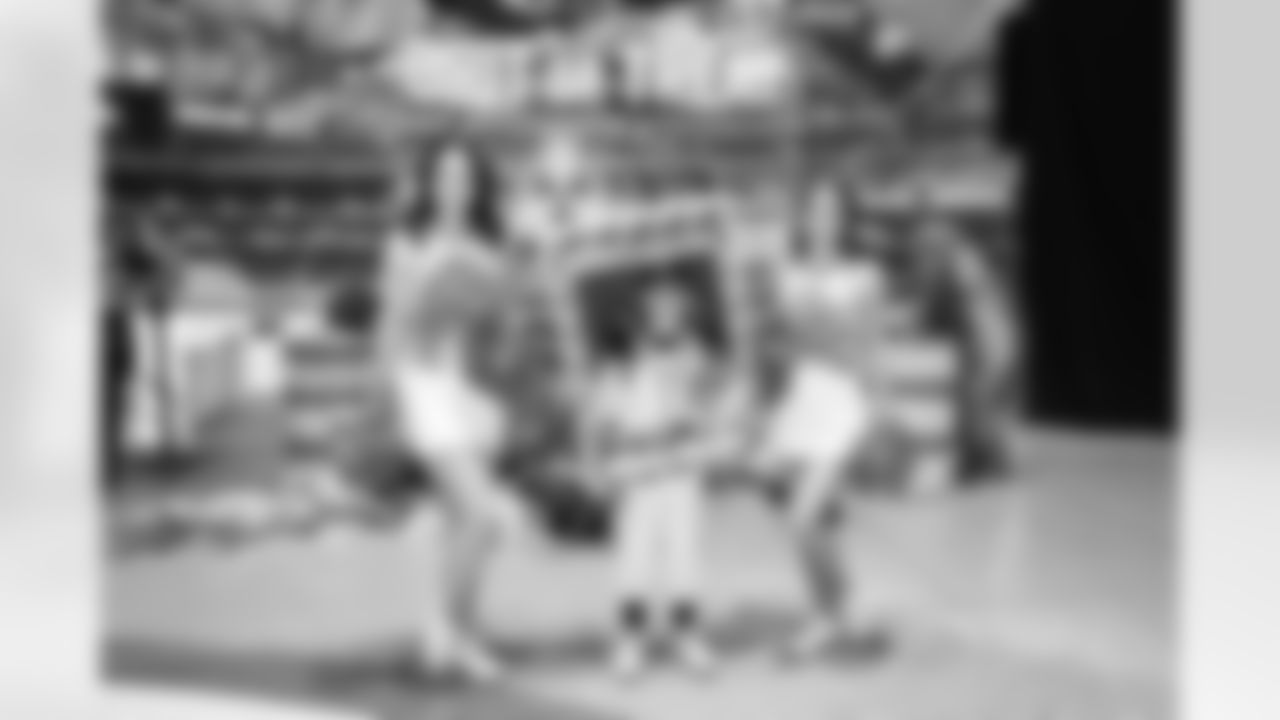 A kid takes a photo with Detroit Lions Cheerleaders during the Cub Club Halloween event at Ford Field on Oct. 29, 2025 in Detroit. (Mike Ferdinande/Detroit Lions)