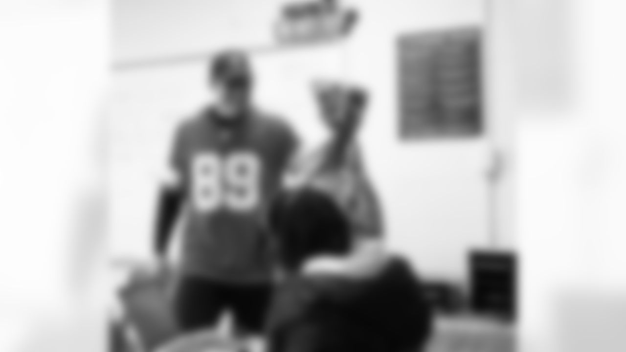 Lions Legend Jeff Chadwick (89) handing out presents during the Presents from the Pride event at Detroit Lions Academy on Dec. 16, 2025 in Detroit. (Izzy Rincon/Detroit Lions)