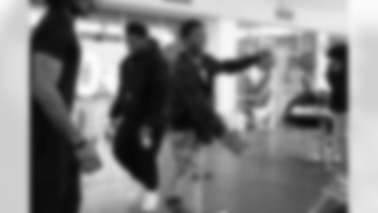 A student smiling while playing cornhole during the Presents from the Pride event at Detroit Lions Academy on Dec. 16, 2025 in Detroit. (Izzy Rincon/Detroit Lions)