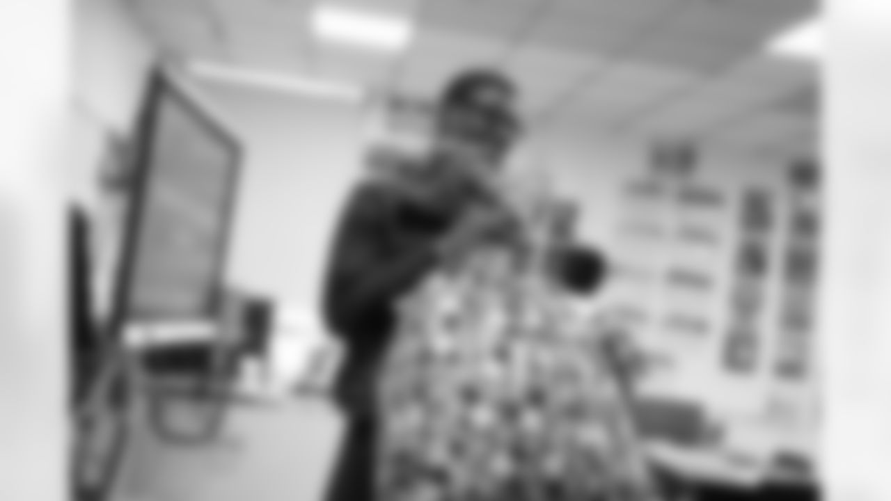 A student holding bags of gifts during the Presents from the Pride event at Detroit Lions Academy on Dec. 16, 2025 in Detroit. (Izzy Rincon/Detroit Lions)