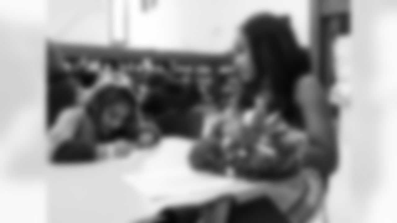 A Detroit Lions Cheerleader interacting with a student during a reading program kickoff event at the Detroit Public Library on June 5, 2025 in Detroit. (Izzy Rincon/Detroit Lions)