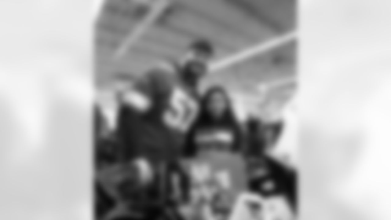 Detroit Lions offensive lineman Trystan Colon (57)  and a participant pose for a photo during Shop with a Lion at Meijer on Dec. 8, 2025 in Detroit. (Izzy Rincon/Detroit Lions)