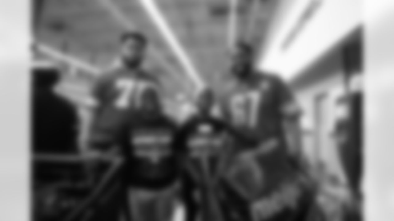 Detroit Lions offensive lineman Miles Frazier (71), participants and Lions Legend Rob Sims (67) pose for a photo during Shop with a Lion at Meijer on Dec. 8, 2025 in Detroit. (Izzy Rincon/Detroit Lions)